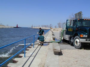 DNR employees stocking fish off pier in Holland