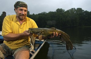 Angler holding a flathead catfish
